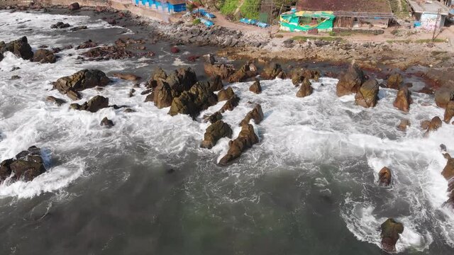 Aerial Coastline Fly between the Cliffs and a Rural Indian Village | Shore