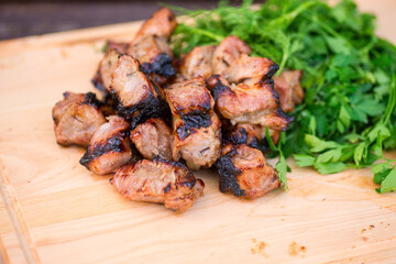grill meat, green on a woowen plate