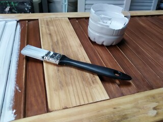 white primer paint with brush on wooden wardrobe door