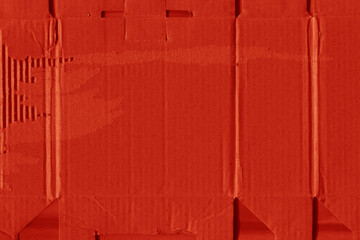 A red vintage rough sheet of carton. Recycled environmentally friendly cardboard paper texture. Simple and bright minimalist papercraft background.