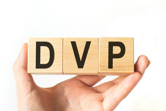 Hand holds wooden cubes with letters dvp. Business concept image.