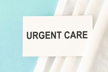 Word urgent care with medical mask on a blue background. Preventive Medicine