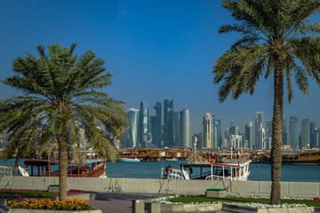 Fototapeta na wymiar View of Doha's Financial District from the Cornish Waterfront with the Dhows moored in the Persian Golf, Qatar.