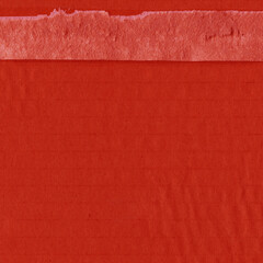Fototapeta premium A red vintage rough sheet of carton. Recycled environmentally friendly cardboard paper texture. Simple and bright minimalist papercraft background.