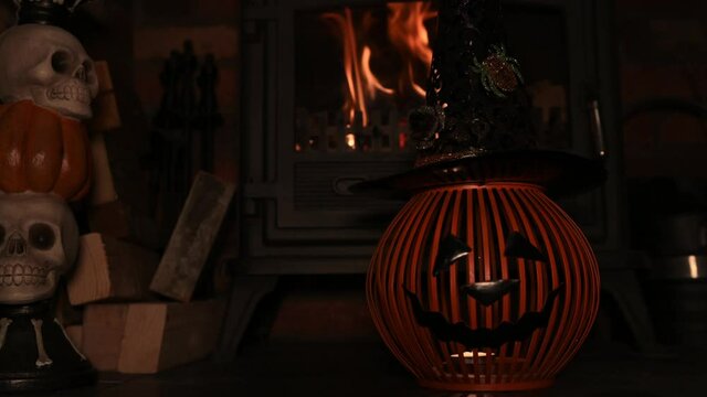 4k video of pumpking Hat on spooky fire place. wram flickering backlight from fire