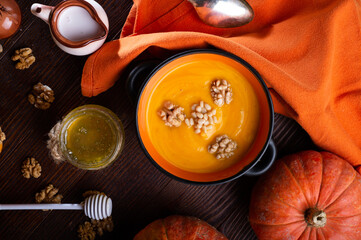 baked pumpkin cream coup with, nuts ,  coconut milk and natural honey served in nice bowl. served...