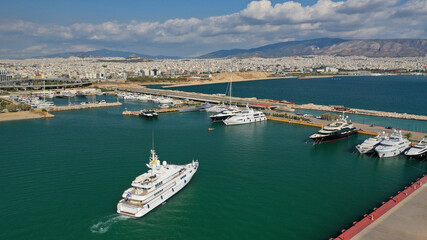 Fototapeta na wymiar Aerial drone top down photo of luxury yacht cruising to Athens Marina and port in Piraeus, Attica, Greece