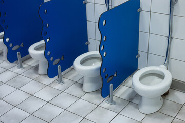 Closeup of little toilets for kids in a school lavatory