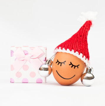funny lovely egg in winter santa hat and ball lika a earring