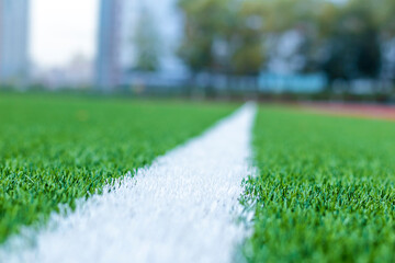 Close-up of an artificial turf. Blurred background in the background, concept healthy lifestyle, sports, morning run