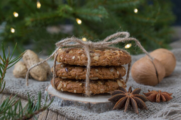 Christmas cookies on the background of a Christmas tree. Oatmeal cookies close-up. Nuts. Happy New Year. Confectionery.