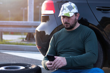 Man calling road assistance on the highway. Calling car service, assistance or  tow truck while...