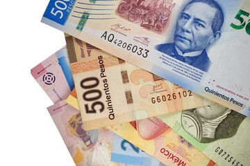 Fototapeta na wymiar Some mexican peso bills isolated on white background