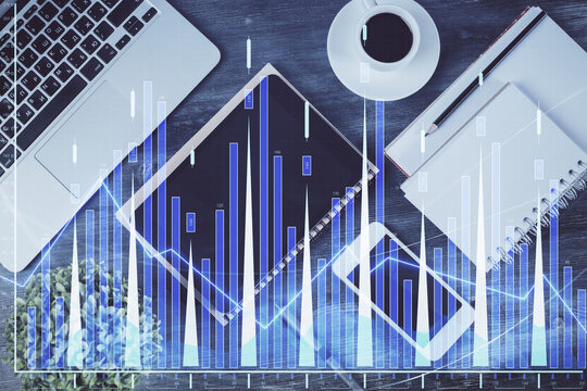 Double exposure of forex chart hologram over desktop with phone. Top view. Mobile trade platform concept.