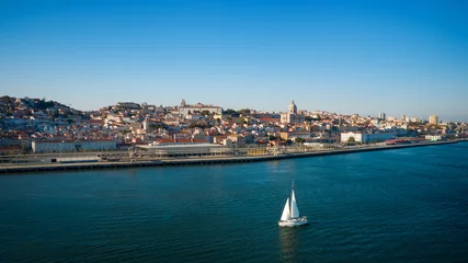 Fensteraufkleber Aerial view of Lisbon city and Tagus river with sailing yacht © Creative Cat Studio