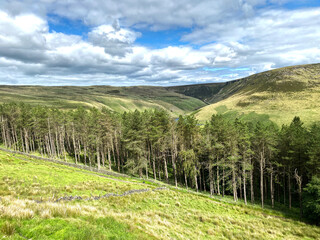 Fototapeta na wymiar Landscape view, from the A635 Holmfirth road, with valleys, trees, and distant hills in, Oldham, Lancashire, UK