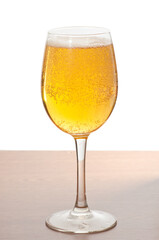 Glass of cold beer over wooden surface