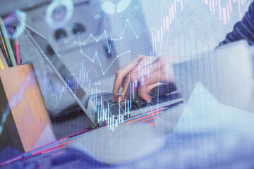 Double exposure of woman hands typing on computer and forex chart hologram drawing. Stock market invest concept.