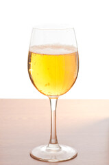 Glass of cold beer over wooden surface