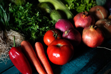 red and green fresh vegetables fruits on blue wood