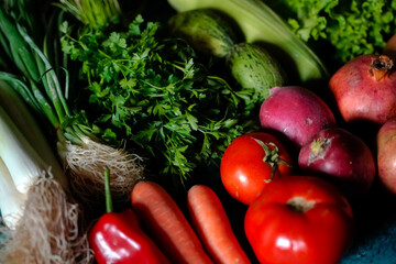 red and green fresh vegetables fruits on blue wood