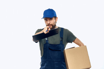 Man in working uniform box delivery loader courier light background