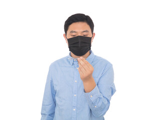 A man wearing a mask checks the thermometer in his hand