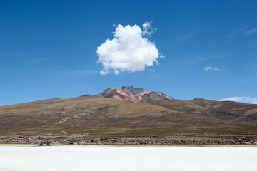 Cloud sits above volcano on the salt flats of Bolivia