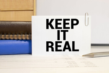 The word keep it real, pinned to a cork board.