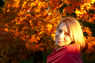 Naklejka na ściany i meble Autumn woman on leafs background