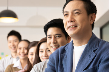 Business asian man stand and wear masks and cross arm in the office.