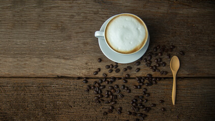 Coffee beans and coffee cup with coffee and coffee beans on table