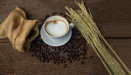 Coffee beans and coffee cup with coffee and coffee beans on table