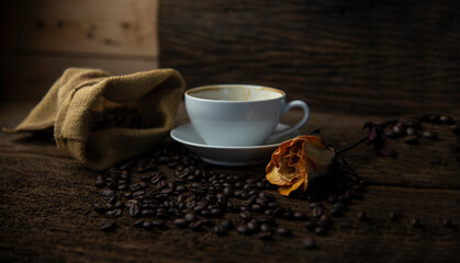 Coffee beans and coffee cup with coffee and coffee beans on table