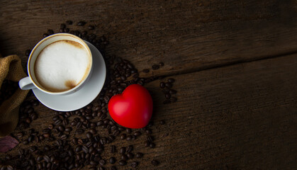 Coffee beans and coffee cup with coffee and coffee beans on table