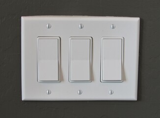 White modern light switch set on a painted interior wall