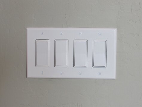 White modern light switch set on a painted interior wall