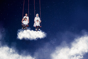 Happy family playing with swing in the sky