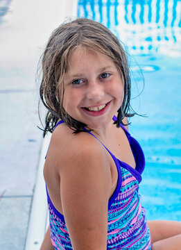 Portrait of a pretty Young lady sitting  pool side