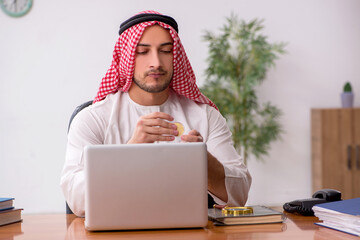 Young male arab employee working in the office