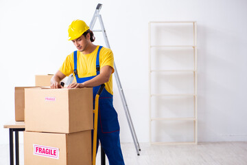 Young male professional mover doing home relocation