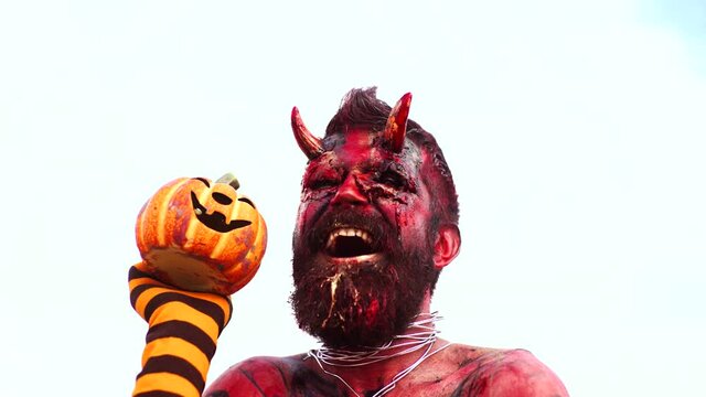 Halloween in blood. Happy Devil head in blood, bloody face. Scary horrorwith spooky monster. Evil portrait with horns. Demon or satan. Fantasy art project for holiday. Realistic gothic monster zombie.