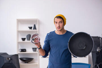 Young male photographer working in the studio