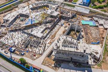 large construction site with working construction cranes. top view of big development construction