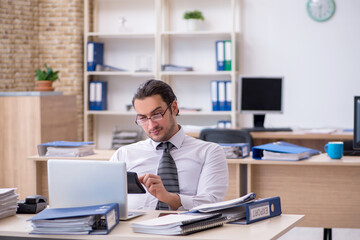 Young male employee unhappy with excessive work