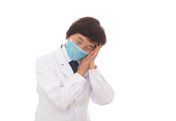 Tired female doctor wearing a mask in front of white background