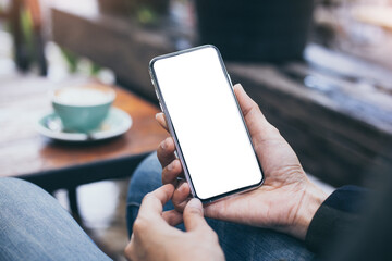 cell phone mockup blank white screen.woman hand holding texting using mobile on desk at coffee shop.background empty space for advertise.work people contact marketing business,technology