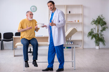 Old neck injured man visiting young male doctor