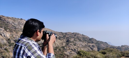 Fototapeta premium Photographer looking through binocular