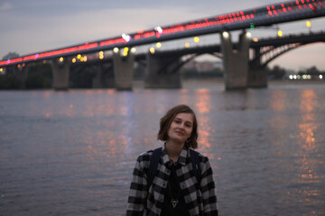 Portrait of a young woman in front of the bridge